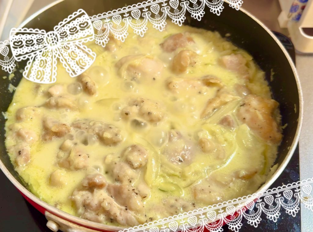 Shkmeruli, Add milk, white wine, and consommé and simmer the chicken.

